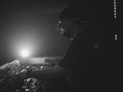 Spotlight shining on techno DJ Avision fron New York in a club