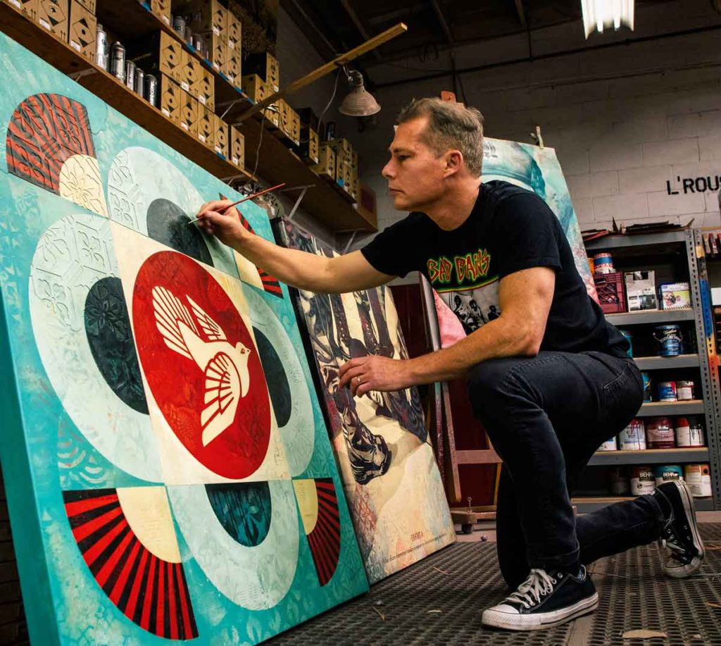 Shepard Fairey painting in studio