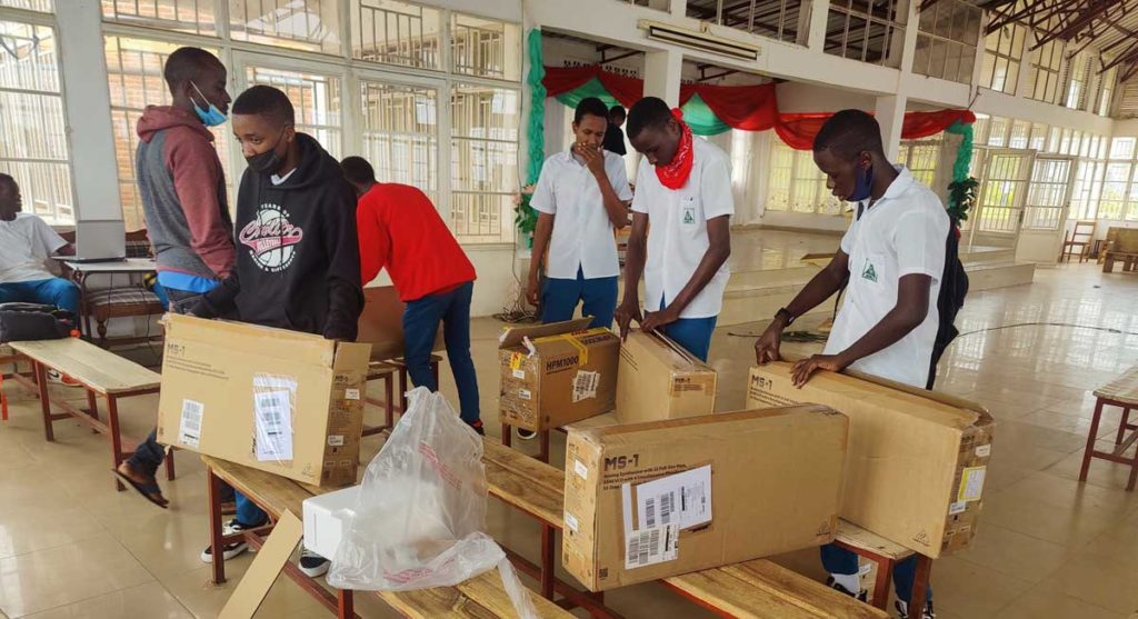 Rwanda kids opening Behringer synth boxes