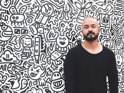 Dubai artist Aham against cartoon wall